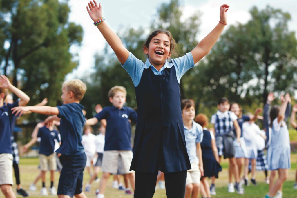 Picture of a girl with arms raised at Curtis School in Los Angeles
