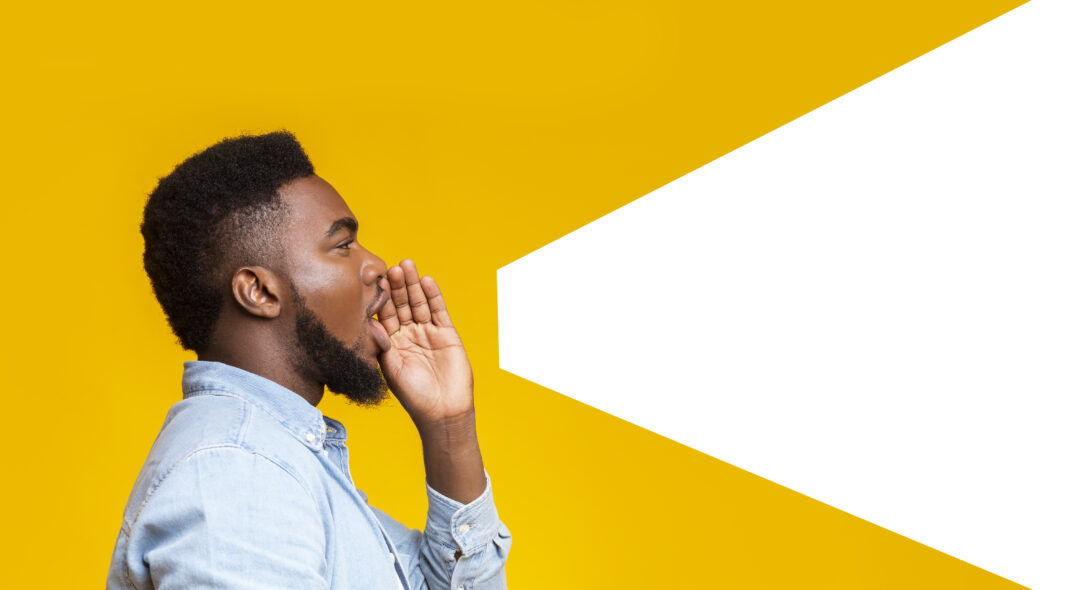 Person shouting into a bold white speech bubble—visual metaphor for a bold fundraising campaign strategy that grabs attention.