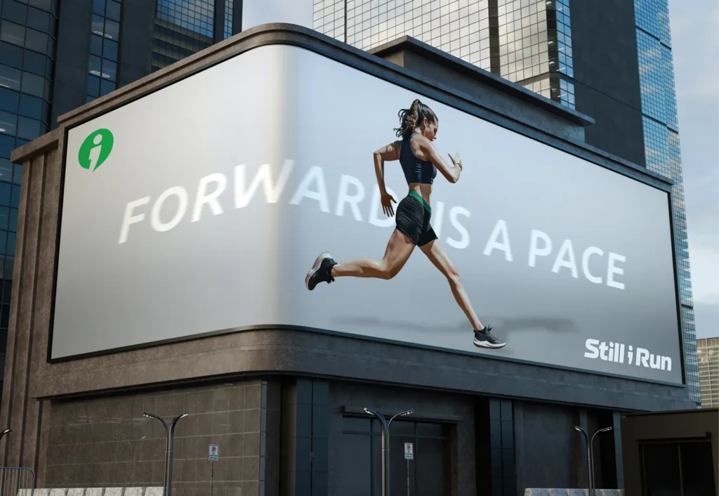A city billboard mockup showing a woman running with the text 'Forward Is a Pace' and the Still I Run logo